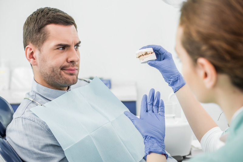 Dentist talking to patient about tooth decay