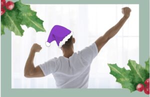 man wearing a purple Santa hat stretching